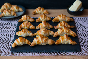 Cheese filled croissants on black slate tray