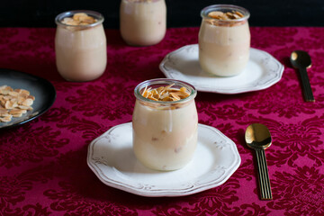 Desserts in glass with laminated almonds