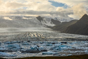 Sunset at the Fjallsárlón glacier and its glacial lagoon and icebergs, Vatnajökull National Park, South Iceland.