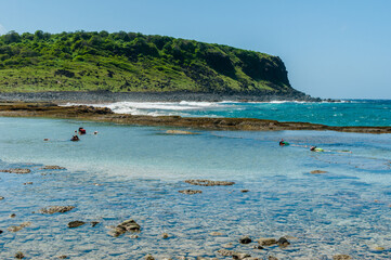 Atalaia beach where there is a natural coral pool and in the background the rock known as the Finger of God in the Fernando de Noronha Archipelago