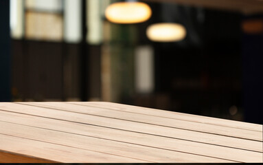 blurred background of bar and dark brown workspace desk made of retro wood
