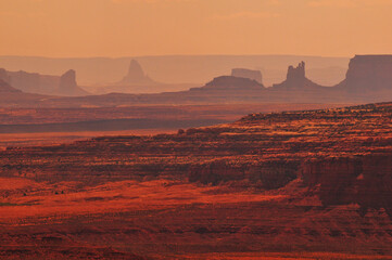 Hazy mid-afternoon view of the distant buttes and mesas of Monument Valley from Muley Point viewpoint, Utah, Southwest USA.