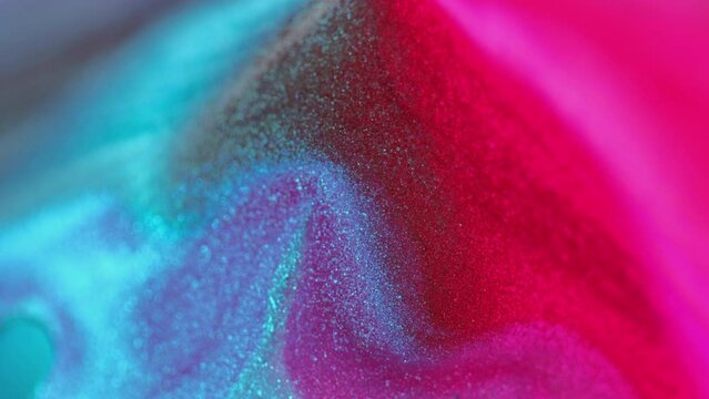 Glitter paint spill. Fluid drip. Defocused neon pink blue black color gradient light metallic texture ink pouring motion pyramid abstract art background.
