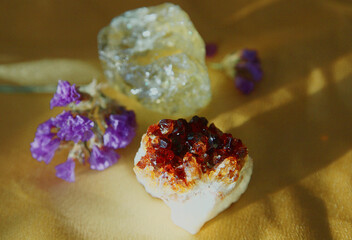 Two pieces of quartz on a golden cloth.