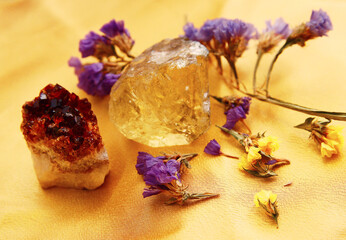 Two pieces of quartz on a golden cloth.