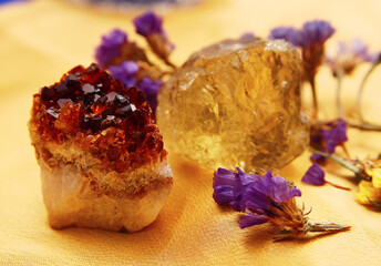 Two pieces of quartz on a golden cloth.