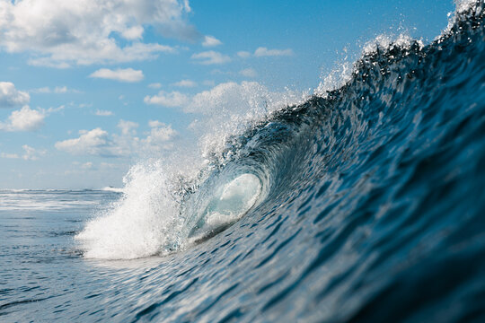 Crashing wave with clear blue sky in the background
