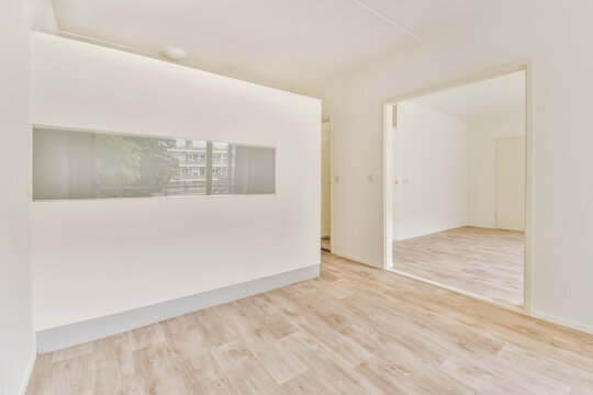 Modern empty room with large window and wooden floor
