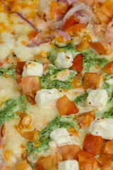 pizza using a large number of different ingredients close-up