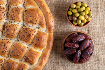 Traditional iftar table with dates fruit, pita, green olives,top view