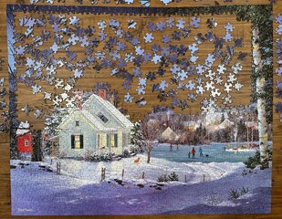 A puzzle on a wooden table halfway completed