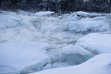 Fototapeta na wymiar Waterfall Storforsen, river in Sweden in the snow