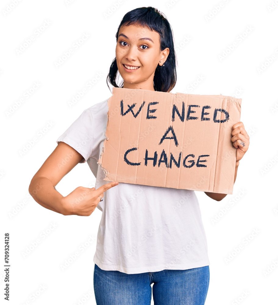 Poster Young woman holding we need a change banner smiling happy pointing with hand and finger