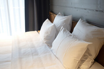 Double bed. Bedroom in hotel. Pillows with white sheets. Bed sheets. Bedroom interior. Bed with pillows close-up. Linens for comfortable sleep. Bunk for two people. Place to stay overnight