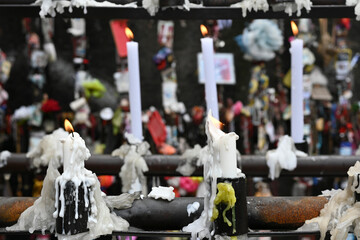religious candles lit in a Catholic place marking fulfillment of promises