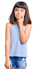 Young little girl with bang wearing casual clothes serious face thinking about question with hand...