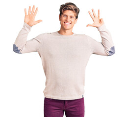 Young handsome man wearing casual clothes showing and pointing up with fingers number nine while...