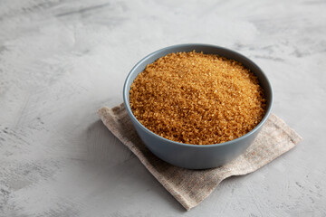 Organic Brown Sugar in a Bowl, side view. Copy space.