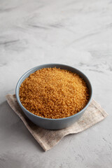 Organic Brown Sugar in a Bowl, side view. Copy space.