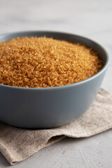 Organic Brown Sugar in a Bowl, side view. Close-up.