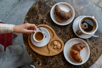 Croissants and coffee in a cafe. Top view, flat lay