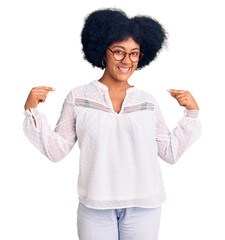 Young african american girl wearing casual clothes looking confident with smile on face, pointing oneself with fingers proud and happy.