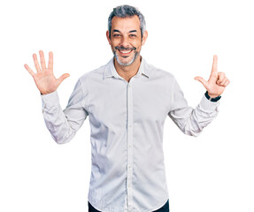 Middle age hispanic with grey hair wearing casual white shirt showing and pointing up with fingers number seven while smiling confident and happy.