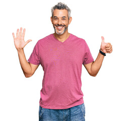 Fototapeta premium Middle age grey-haired man wearing casual clothes showing and pointing up with fingers number six while smiling confident and happy.