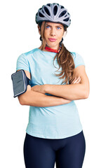 Beautiful caucasian young woman wearing bike helmet skeptic and nervous, disapproving expression on face with crossed arms. negative person.
