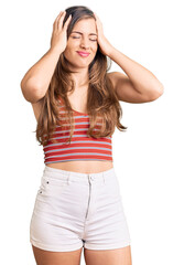 Beautiful caucasian young woman wearing casual clothes suffering from headache desperate and stressed because pain and migraine. hands on head.