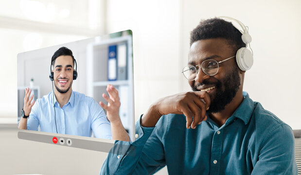 Black businessman immersed in virtual meeting with colleague at office