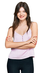 Young beautiful caucasian girl wearing casual clothes happy face smiling with crossed arms looking at the camera. positive person.