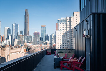 View of modern tall buildings and traditional apartment buildings seen from roof deck in Brooklyn,...