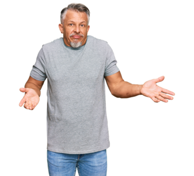 Middle age grey-haired man wearing casual clothes clueless and confused expression with arms and hands raised. doubt concept.