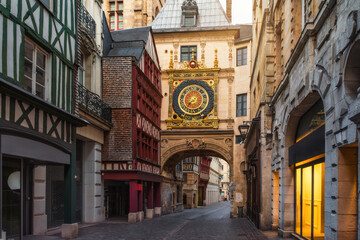 Medieval cozy street in Rouen with famos Great clocks or Gros Horloge of Rouen, Normandy, France with nobody. Architecture and landmarks of Normandie - obrazy, fototapety, plakaty