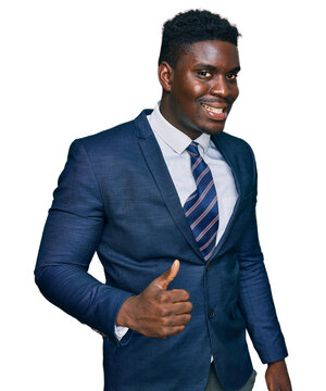 Handsome business black man wearing business suit and tie doing happy thumbs up gesture with hand. approving expression looking at the camera showing success.