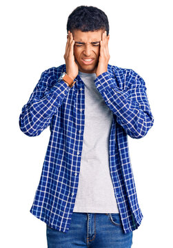 Young african amercian man wearing casual clothes with hand on head, headache because stress. suffering migraine.