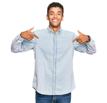 Young handsome african american man wearing casual clothes looking confident with smile on face, pointing oneself with fingers proud and happy.