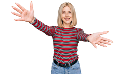 Young blonde woman wearing casual clothes looking at the camera smiling with open arms for hug. cheerful expression embracing happiness.