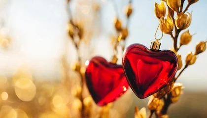 Fotobehang two red glass hearts on golden branches with beautiful light love and date st valentines day card 14 february wedding invitation or thank you concept wide banner with copy space © Claudio