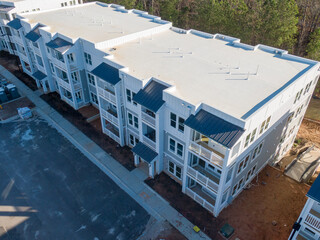 Professional Aerial Drone Photo of An Apartment Building Under Construction With A TPO Roof: Architecture, Construction, Industry, Real Estate
