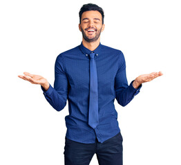 Young handsome hispanic man wearing business clothes celebrating mad and crazy for success with...
