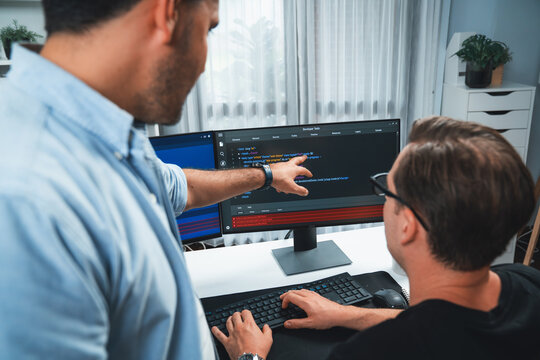 IT developers pointing on software development information on two screens with coding program in application and website. Technical engineer coder analyzing in safety program concept. Sellable.
