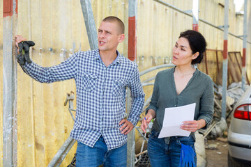 Farmer signing contract with representative of transport company outdoors