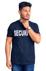 Handsome latin american young man wearing security t shirt touching painful neck, sore throat for flu, clod and infection