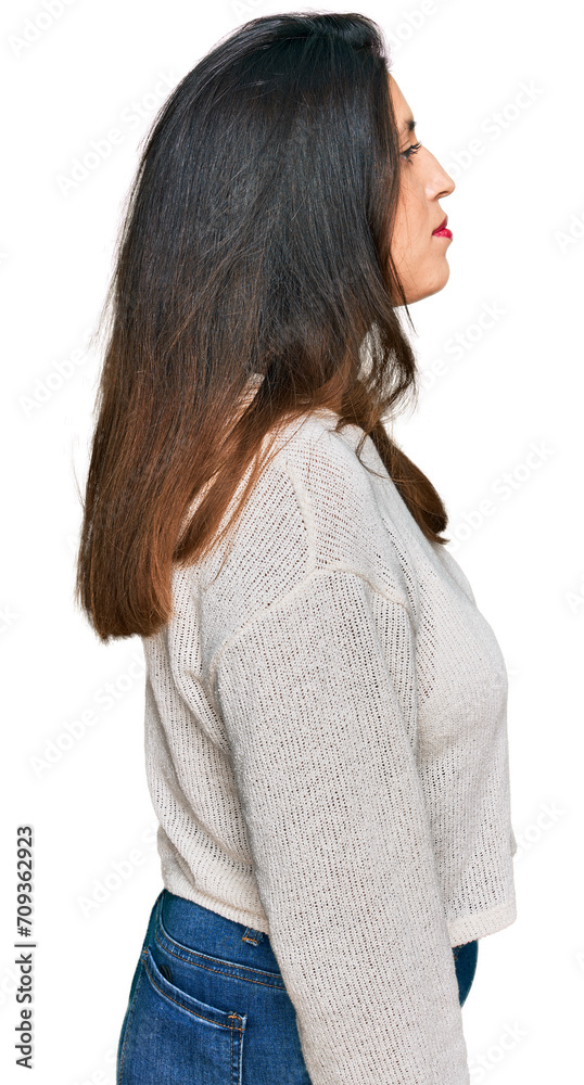 Sticker beautiful hispanic woman wearing casual sweater looking to side, relax profile pose with natural fac