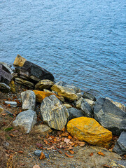 rocky beach by the lake in autumn, note shallow depth of field