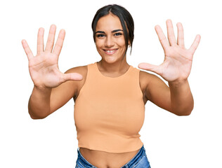 Young brunette woman wearing casual clothes showing and pointing up with fingers number ten while smiling confident and happy.