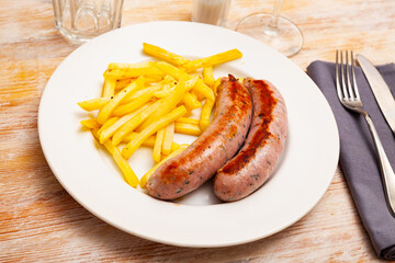 Image of tasty fried meat sausages served with french fries, nobody