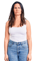 Young beautiful brunette woman wearing casual sleeveless t-shirt depressed and worry for distress, crying angry and afraid. sad expression.